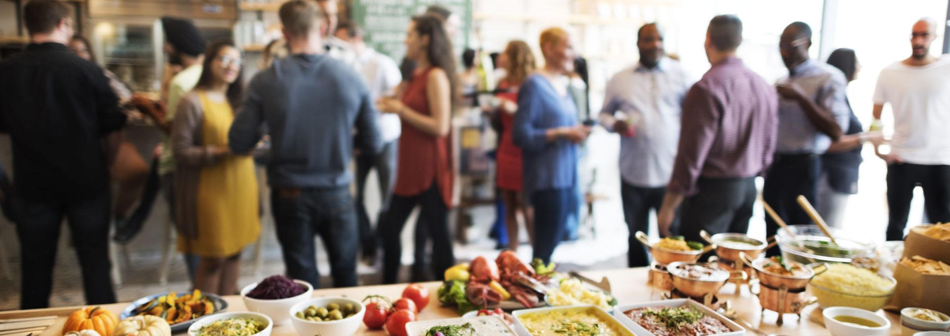 a group of people standing around a buffet table at The Swifty Skills Session