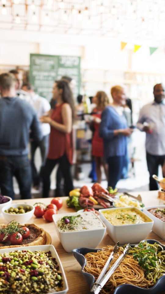 a group of people standing around a buffet table at The Swifty Skills Session