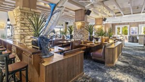 a restaurant with a large bar and a large fish tank at The Swifty Skills Session