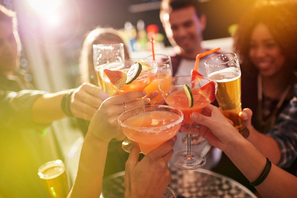 a group of people toasting drinks at a bar at The Swifty Skills Session