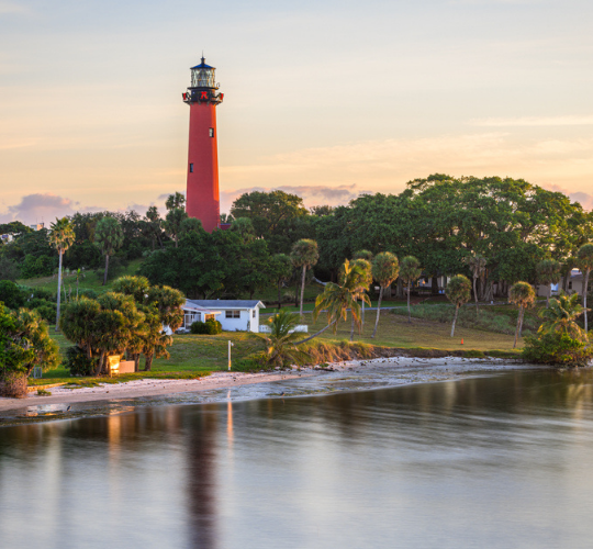 a lighthouse is seen in the distance by the water at The Swifty Skills Session